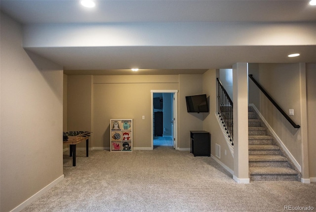 finished basement featuring stairway, baseboards, and carpet floors