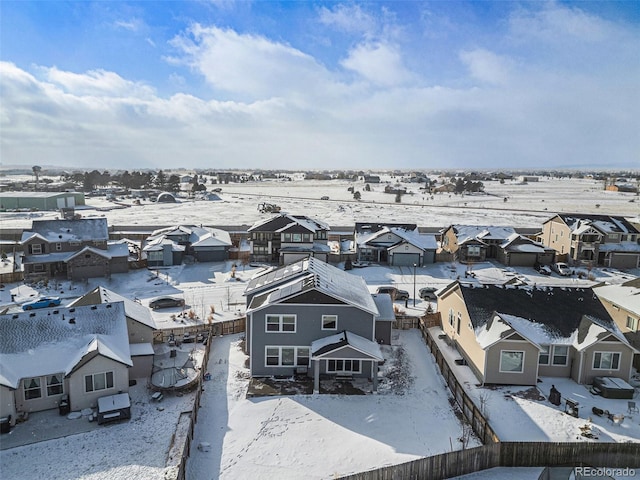 snowy aerial view with a residential view