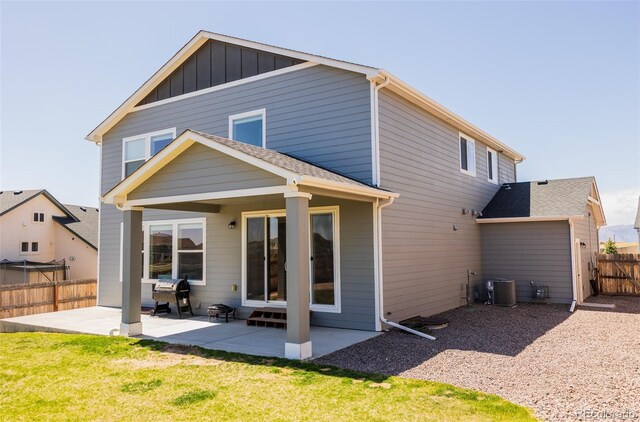 8073 Wheatland Dr, Colorado Springs, CO 80908 - back of property featuring a lawn, a patio, fence, and central AC unit