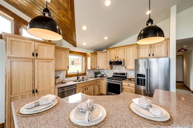 kitchen featuring stainless steel appliances, light brown cabinets, a sink, vaulted ceiling, and backsplash