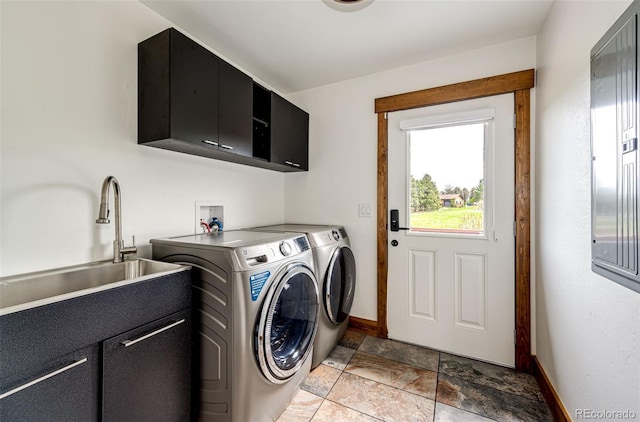 laundry room featuring cabinet space, washer and clothes dryer, baseboards, and light stone finish floors