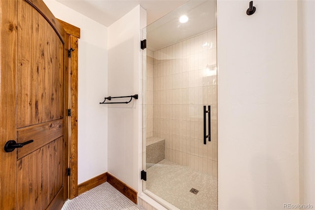 bathroom with baseboards, a shower stall, and recessed lighting