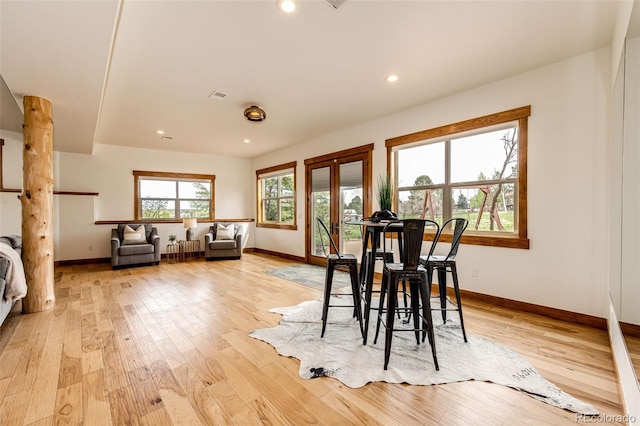 dining area featuring baseboards, light wood-style flooring, and recessed lighting