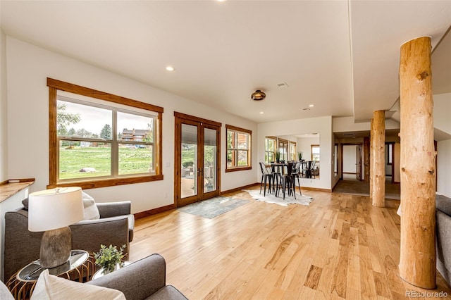 entryway with light wood finished floors, french doors, baseboards, ornate columns, and recessed lighting