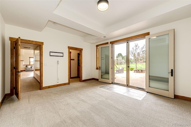 unfurnished room with light colored carpet and baseboards