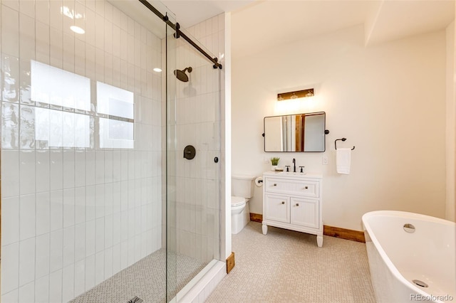 full bathroom with a stall shower, vanity, a freestanding tub, and toilet