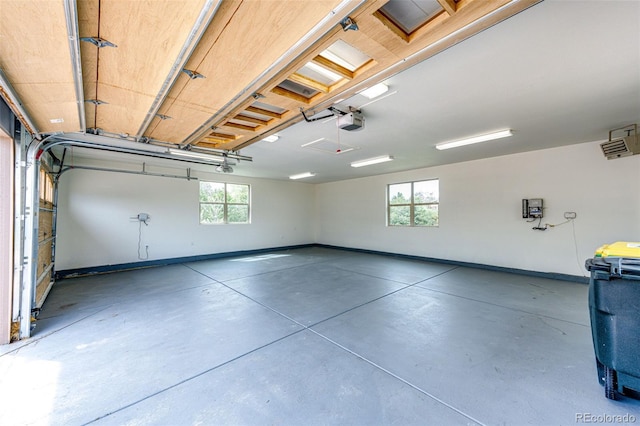 garage with a garage door opener and baseboards