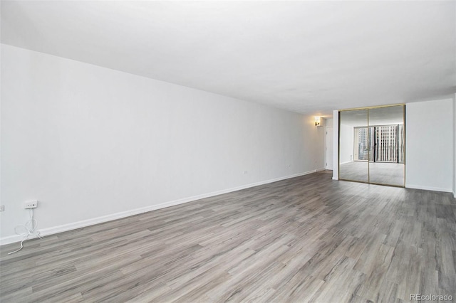 1020 15th St Unit 15G, Denver, CO 80202 - empty room featuring wood finished floors and baseboards