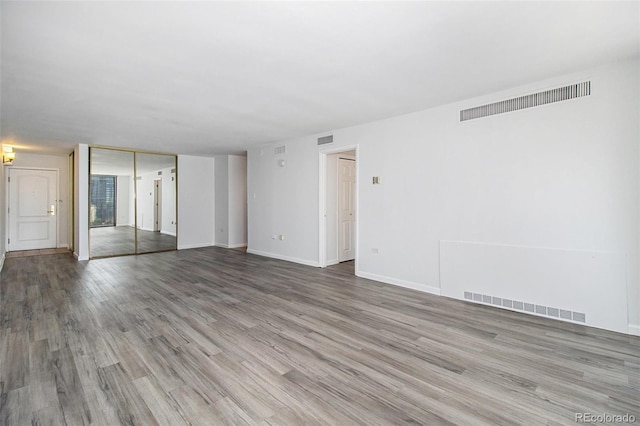 1020 15th St Unit 15G, Denver, CO 80202 - unfurnished room featuring wood finished floors and baseboards