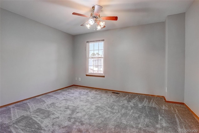 carpeted empty room featuring ceiling fan