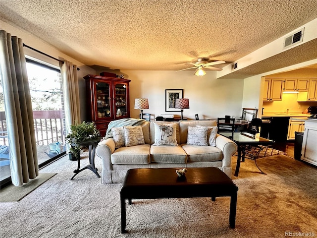 12565 Sheridan Blvd Unit 212, Broomfield, CO 80020 - living area with carpet floors, a textured ceiling, and ceiling fan