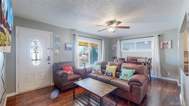 living area featuring baseboards, wood finished floors, and a ceiling fan