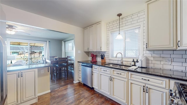 kitchen featuring stainless steel dishwasher, a sink, a wealth of natural light, and ceiling fan