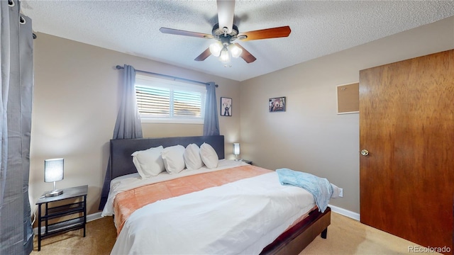 bedroom with baseboards, a textured ceiling, a ceiling fan, and carpet