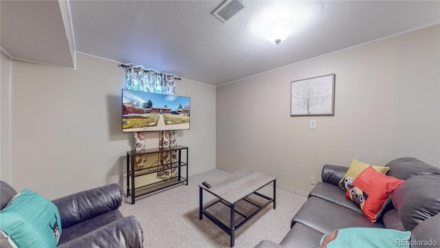 living area with visible vents and carpet