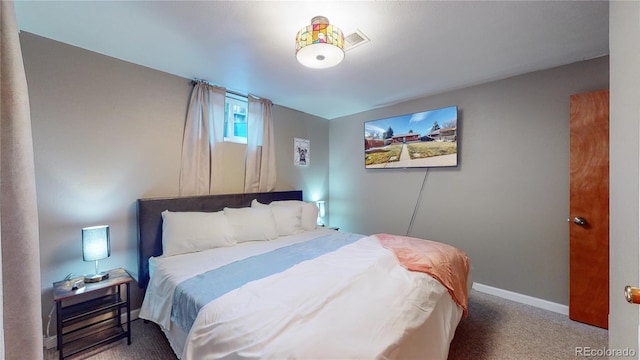 bedroom featuring baseboards and carpet flooring