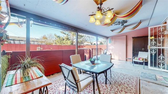 sunroom featuring a notable chandelier