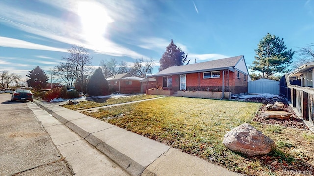 bungalow-style house featuring brick siding, a front lawn, and fence