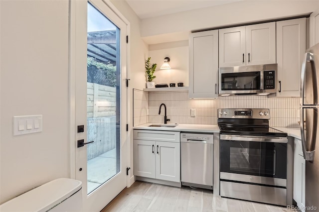 4025 Jason St Unit 101, Denver, CO 80211 - kitchen with stainless steel appliances, light countertops, tasteful backsplash, and open shelves
