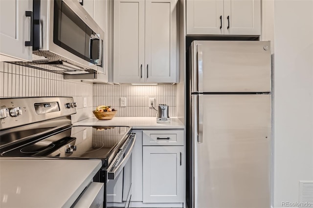 4025 Jason St Unit 101, Denver, CO 80211 - kitchen with stainless steel appliances, decorative backsplash, and light countertops