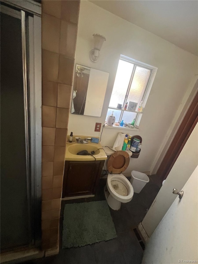 bathroom featuring vanity, tile patterned floors, and toilet