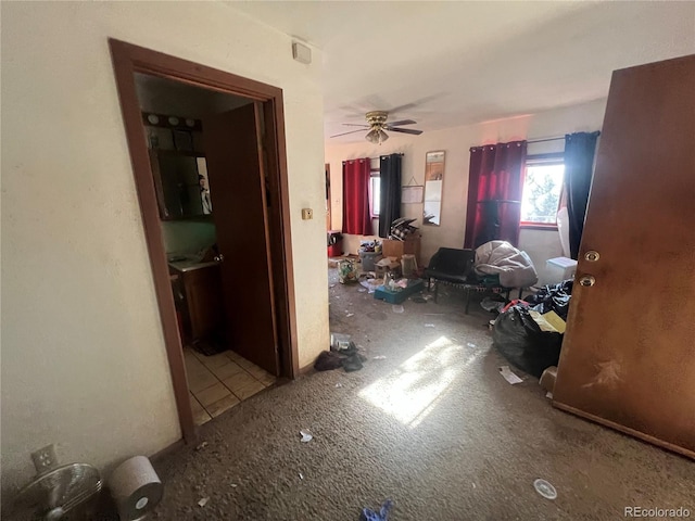 interior space featuring ceiling fan and carpet floors