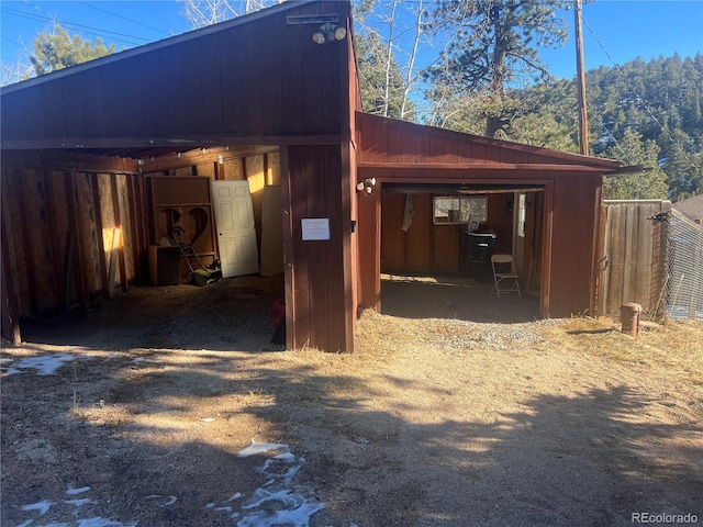 view of property exterior with an outbuilding