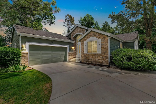 7400 W Grant Ranch Blvd Unit 52, Littleton, CO 80123 - ranch-style home featuring stone siding, an attached garage, concrete driveway, and roof with shingles