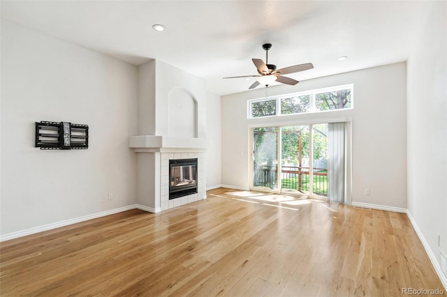 7400 W Grant Ranch Blvd Unit 52, Littleton, CO 80123 - unfurnished living room with a ceiling fan, a tile fireplace, wood finished floors, and recessed lighting