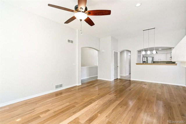 7400 W Grant Ranch Blvd Unit 52, Littleton, CO 80123 - unfurnished living room with arched walkways, ceiling fan, light wood finished floors, and recessed lighting