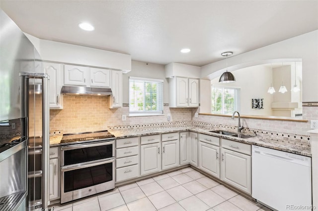 7400 W Grant Ranch Blvd Unit 52, Littleton, CO 80123 - kitchen with appliances with stainless steel finishes, under cabinet range hood, healthy amount of natural light, white cabinets, and recessed lighting