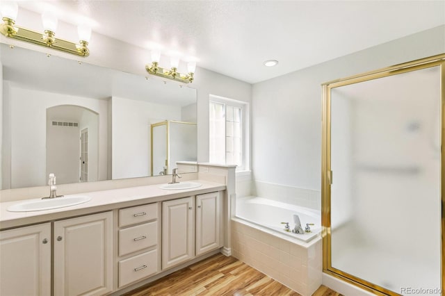 7400 W Grant Ranch Blvd Unit 52, Littleton, CO 80123 - full bath featuring a shower stall, a bath, double vanity, and wood finished floors