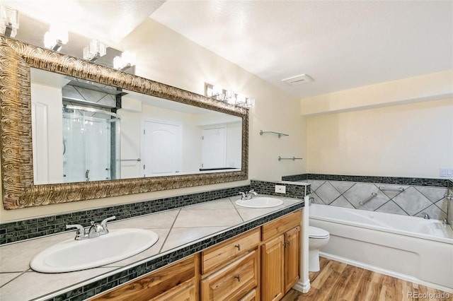 7400 W Grant Ranch Blvd Unit 52, Littleton, CO 80123 - full bath with a bath, double vanity, wood finished floors, and a stall shower