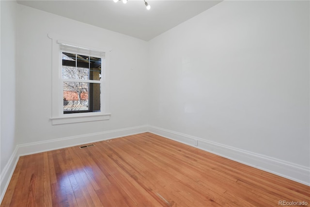 unfurnished room featuring hardwood / wood-style flooring