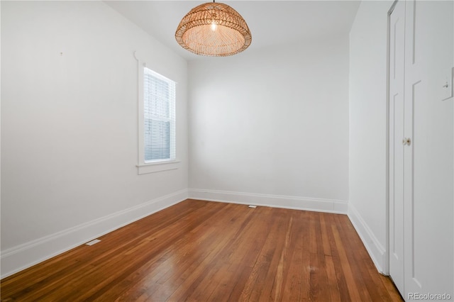 spare room featuring wood-type flooring