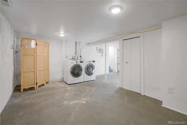 clothes washing area featuring independent washer and dryer