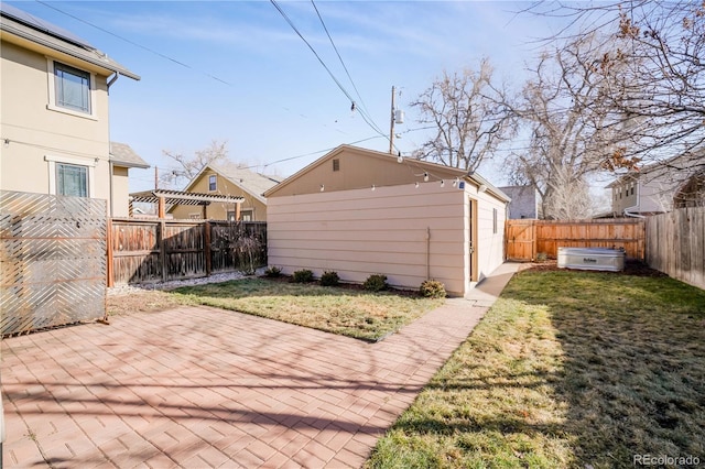 view of patio with an outbuilding, a pergola, and a jacuzzi