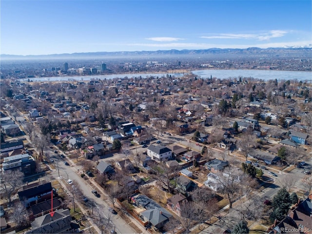 birds eye view of property with a water and mountain view