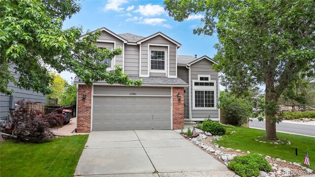 11301 Vernon Way, Parker, CO 80134 - traditional-style home featuring brick siding, a front lawn, driveway, a garage, and roof with shingles