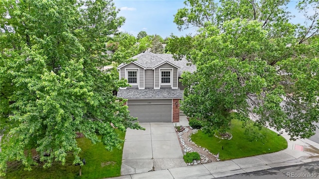 11301 Vernon Way, Parker, CO 80134 - view of front of house with driveway, brick siding, an attached garage, and a shingled roof