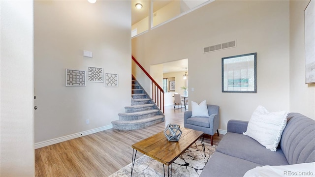 11301 Vernon Way, Parker, CO 80134 - living area featuring stairs, baseboards, wood finished floors, and a towering ceiling