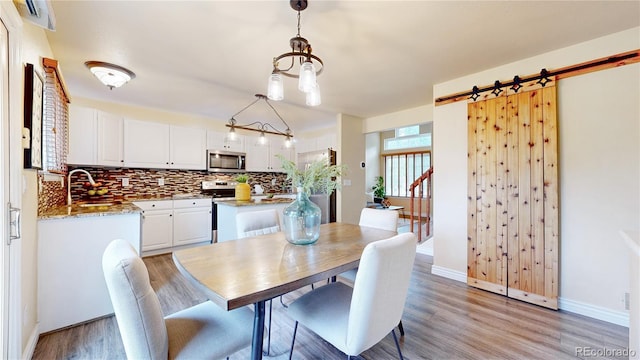 11301 Vernon Way, Parker, CO 80134 - dining space with light wood-style floors, baseboards, and a chandelier