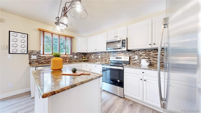 11301 Vernon Way, Parker, CO 80134 - kitchen with stainless steel appliances, light wood-style flooring, light stone counters, and white cabinetry