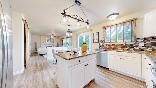 11301 Vernon Way, Parker, CO 80134 - kitchen with appliances with stainless steel finishes, ceiling fan, a center island, backsplash, and stone countertops