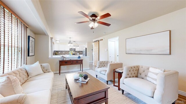 11301 Vernon Way, Parker, CO 80134 - living area featuring ceiling fan, baseboards, and a chandelier