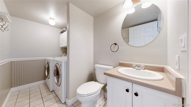 11301 Vernon Way, Parker, CO 80134 - bathroom featuring separate washer and dryer, vanity, tile patterned floors, toilet, and baseboards