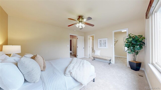 11301 Vernon Way, Parker, CO 80134 - bedroom with a spacious closet, light carpet, baseboards, a ceiling fan, and a closet