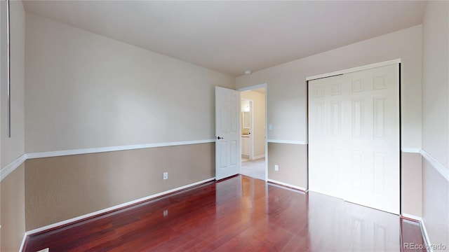 11301 Vernon Way, Parker, CO 80134 - unfurnished bedroom featuring wood finished floors, baseboards, and a closet