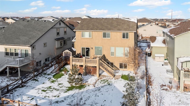 snow covered rear of property featuring a wooden deck