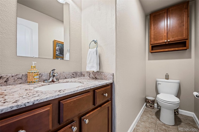 bathroom featuring vanity, toilet, and tile patterned flooring